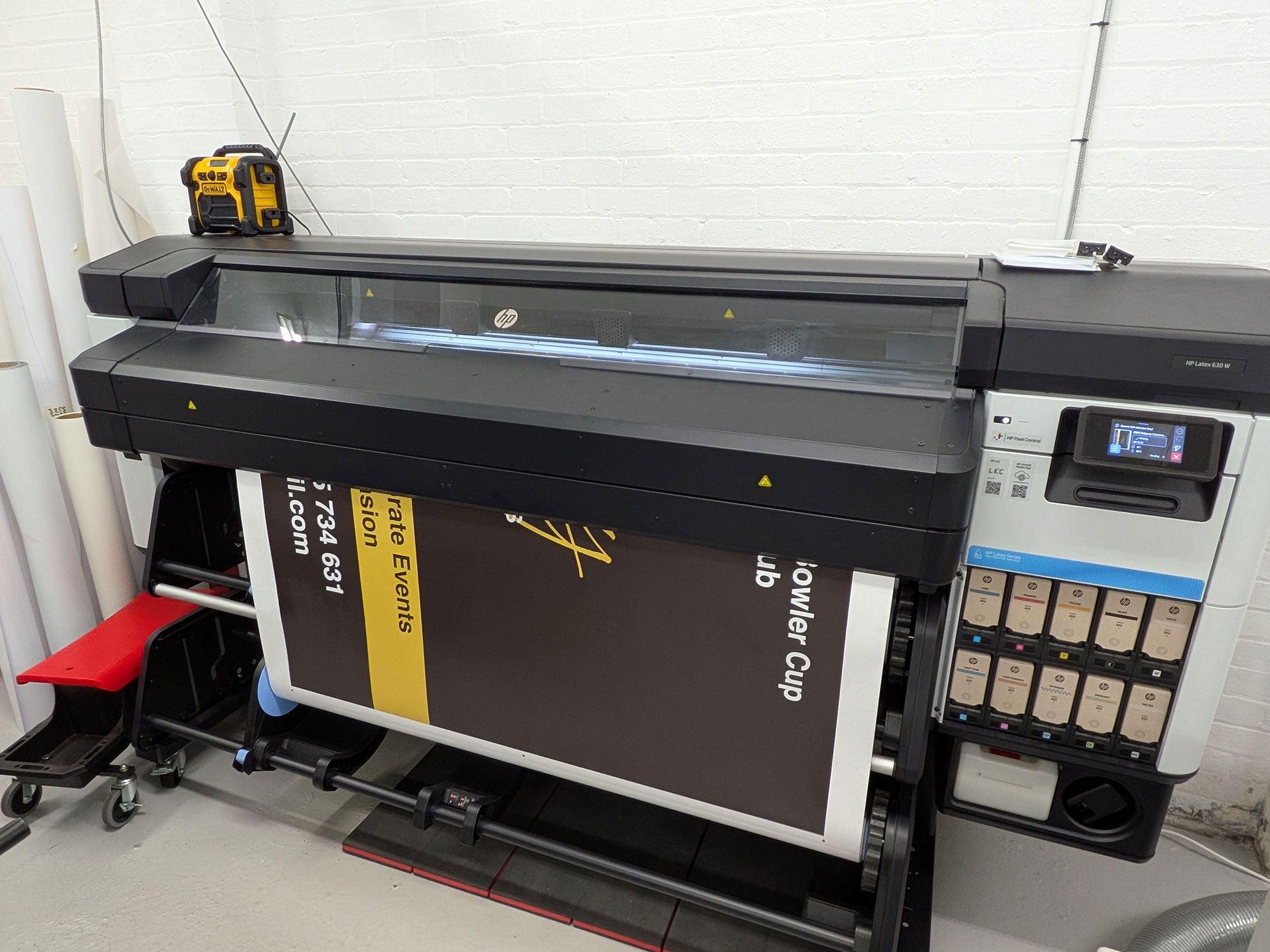 The HP wide format printer in action - Luv Print